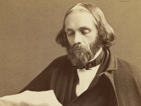 A sepia-toned Edward Everett Hale from 1870, he's bearded and balding in a black coat